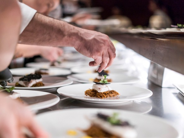 Chef plating up food at a restaurant
